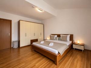 a large bedroom with a large bed and wooden floors at Villa Apricot in Split