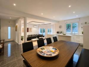 a kitchen and living room with a wooden table and chairs at Villa Apricot in Split