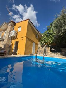 a swimming pool in front of a house at Casa da Prima in Torre de Moncorvo