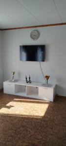 a white living room with a tv on a wall at Eina house near the E4 road in Eina