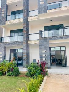 an apartment building with balconies and plants at Kigali Clever stay Villaa in Kigali