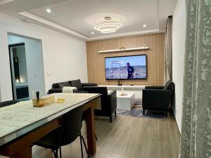 a living room with a television on a wall at Appart Angel in Espargos +3 photos