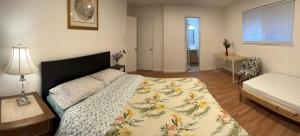 a bedroom with a bed and a table with a lamp at BM master suite in Mountain View in Mountain View +1 photo