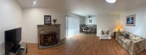 a living room with a fireplace and a couch at BM master suite in Mountain View in Mountain View