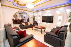a living room filled with furniture and a tv at XTENDED STAY Gh in Accra