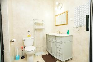a bathroom with a toilet and a sink and a shower at XTENDED STAY Gh in Accra +58 photos