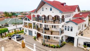 an aerial view of a large white house with a car at XTENDED STAY Gh in Accra