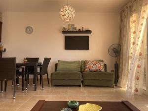 a living room with a couch and a table at 396 Blumar Chalet North Coast Sidi-abdelrahman families & couples only in El Alamein