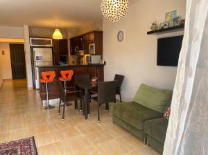 a living room with a couch and a table and chairs at 396 Blumar Chalet North Coast Sidi-abdelrahman families & couples only in El Alamein