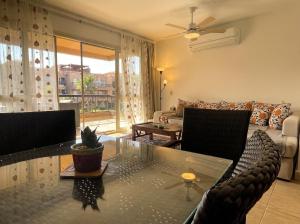 a living room with a table and a couch at 396 Blumar Chalet North Coast Sidi-abdelrahman families & couples only in El Alamein