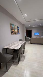 a conference room with a wooden table and chairs at Lovely Residence in Al Khobar +56 photos