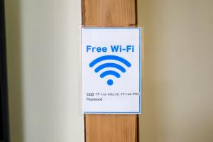 a sign on a wall with a wifi sign on it at yadobankkukomae19 in Fukuoka +27 photos