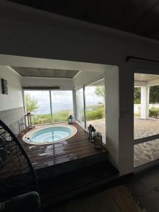 a house with a pool and a deck with a view at Sunrise House Azores - jacuzzi in Senhora da Nazaré