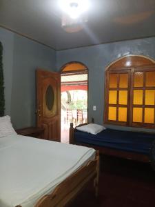 a bedroom with two beds and a window at El Mexican in Moyogalpa