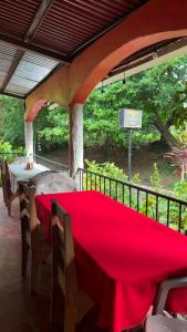 a table with a red table cloth on a patio at El Mexican in Moyogalpa