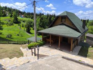 an overhead view of a house with a green roof at Apartmani Slavko in Konjska Reka
