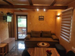 a living room with a couch and a table at Apartmani Slavko in Konjska Reka