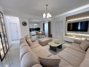 a living room with a large couch and a tv at Villa Joel in Kefallonia