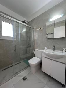 a bathroom with a shower and a toilet and a sink at Villa Joel in Kefallonia +17 photos