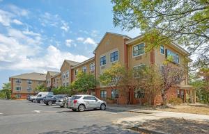 a building with cars parked in a parking lot at Extended Stay America Suites - Long Island - Bethpage in Bethpage