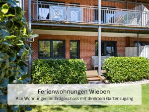 a building with a sign in front of it at Ferienwohnung Wieben Sankt Peter-Ording in Böhl