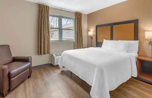 a hotel room with a large bed and a chair at Extended Stay America Suites - West Palm Beach - Northpoint Corporate Park in West Palm Beach +29 photos