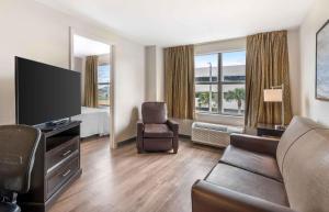 a living room with a flat screen tv and a couch at Extended Stay America Suites - West Palm Beach - Northpoint Corporate Park in West Palm Beach