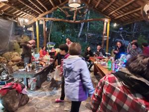 a group of people sitting at tables in a room at Hong Wa Cuo南投埔里紅瓦厝山居民宿森林系住宿生態手作體驗 in Puli