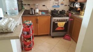 a kitchen with an oven and a stove top oven at Chalet with roof pool view in Dawwār ‘Abd Allāh