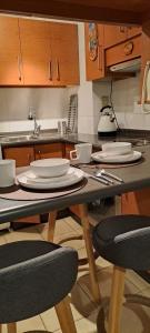 a kitchen with a table with plates on it at Acogedor departamento en La Serena in La Serena
