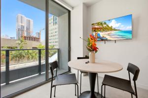a dining room with a table and chairs and a large window at The York Suite Miami in Miami