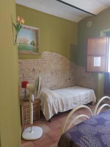 a bedroom with a bed and a table with a fan at B&B Cà Giovanni Country Resort Pet Friendly in Urbino +67 photos