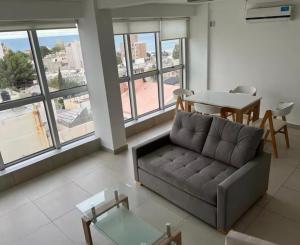 a living room with a couch and a table at The View Comodoro in Comodoro Rivadavia
