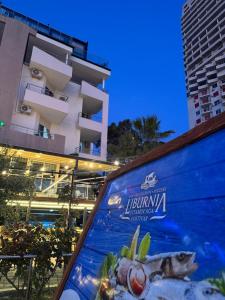 a billboard with a fish on it in front of a building at Hotel Liburnia Vitamin Aga in Golem