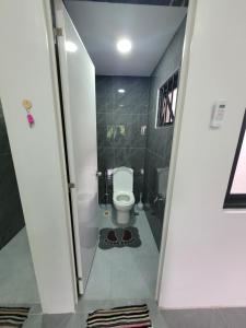 a small bathroom with a toilet in a hallway at MAOS Building in Batangas City