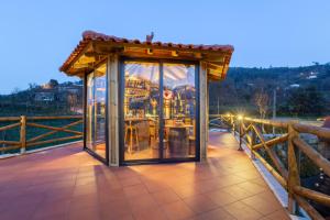 a gazebo on a bridge with a building at Quinta da Eira do Prado in Carvalho