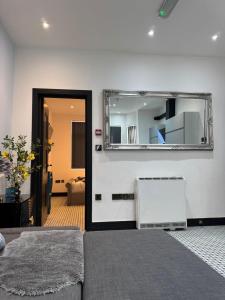 a room with a mirror on the wall at Dove & Gold in Gloucestershire