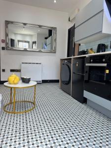 a kitchen with a table and a mirror at Dove & Gold in Gloucestershire +16 photos