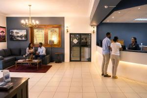 a group of people standing in a waiting room at Sundown Country Estate in Boshoek +87 photos