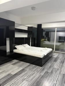 a bedroom with a bed and a large mirror at Rania Penthouse 1 in Şelimbăr