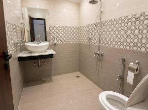 a bathroom with a sink and a shower at The 430 Nexus in Islamabad