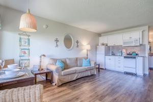 a living room with a couch and a kitchen at Neskowin Resort 114 in Neskowin