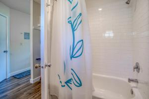 a bathroom with a shower curtain with a blue flower on it at Neskowin Resort 114 in Neskowin