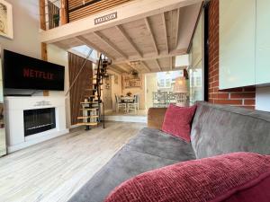 a living room with a couch and a fireplace at Domek Lawenda z Ogrodem, konsolą PS4 z grami, Netflixem i Bezpłatnym Parkingiem in Szczecin