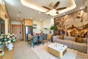 a living room with a couch and a table at The Pathway Condotel in Sầm Sơn