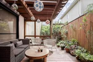 a patio with a couch and chairs and a table at Kasumi-an in Kumamoto
