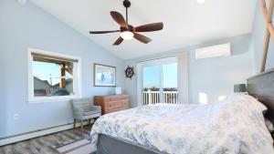 a bedroom with a bed and a ceiling fan at Sunset Retreat in North Cape May