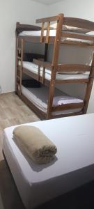 a bunk bed with a pillow on top of it at Assel Pousada Botanico in Curitiba +23 photos