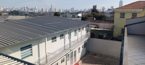 a view of a building with a city in the background at Assel Pousada Botanico in Curitiba