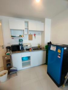 a kitchen with a blue refrigerator and a sink at wongwian N in Ban Bo Khaem